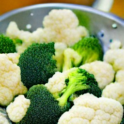 draining steamed veggies in a colander.
