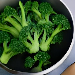 a bowl of broccoli stems, heads, onions, and raisins.