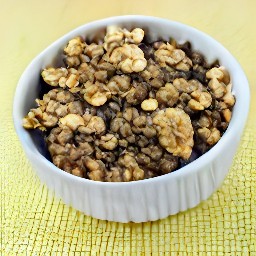 the toasted walnuts are transferred to a bowl.