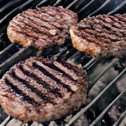 the semi-cooked burger patties are now flipped over.
