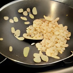 the flaked almonds are added to the second pan and heated.