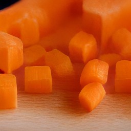 diced carrots and celery sticks, then peeled and chopped onion.