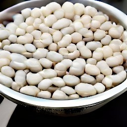 the white beans are drained in the colander.