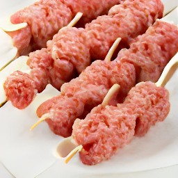 there ovals beyond the patties on the skewers.
