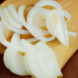 a peeled and sliced yellow onion, and two peeled garlic cloves.