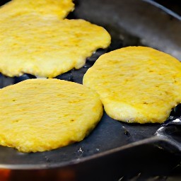 three meatless burger patties with gouda cheese melted on top.