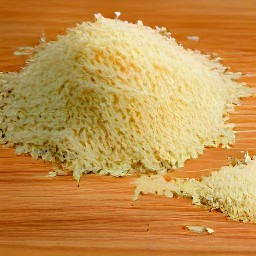 the parmesan cheese is shredded into small pieces.