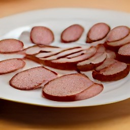 the cooked sausage is transferred to a plate.