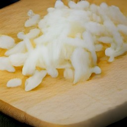 after peeling the onion and garlic, they are diced. the parsley is then chopped.