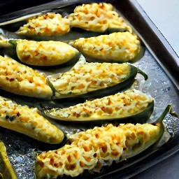 a sheet pan filled with jalapeno peppers and sprinkled with the rest of the crumbled burger patties.