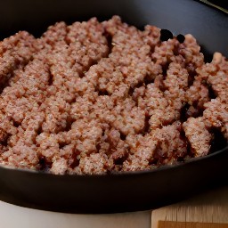 the cooked burger patties are crumbled and removed from the heat.
