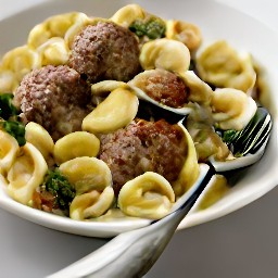 the cooked pasta and veggies mixture is transferred to a serving plate.