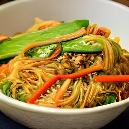 a bowl of lo mein topped with sesame seeds and shiitake mushrooms.