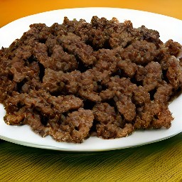 the cooked crumbled burger patties are transferred to a plate.