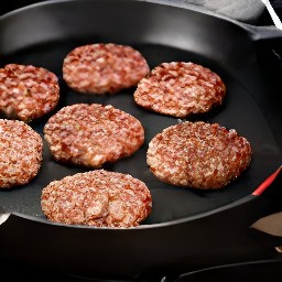 the meatless burger patties are flipped with a spoon.