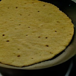 a corn tortilla that has been fried for two minutes on one side.