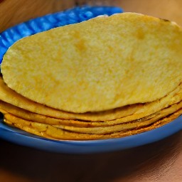 the tortillas are transferred to a plate.