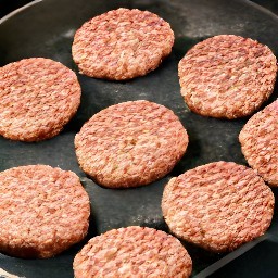 the meatless burger patties are flipped with a spoon.