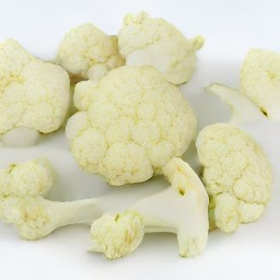 garlic that is peeled and trimmed, and cauliflower that is cut into florets.