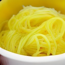 the spaghetti is transferred to a bowl.