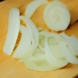 yellow onions and garlic that are peeled and sliced.