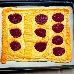 a folded puff pastry with beets in the center.
