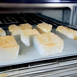 a toaster tray with 10 minutes worth of bread cubes inside of it.