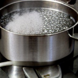 8 cups of water boiling in a saucepan with half a teaspoon of salt.