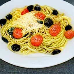 a plate of spaghetti with tomato sauce and parmesan cheese.