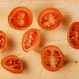 the cherry tomatoes are cut in half.