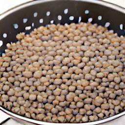 the cooked lentils are drained in a colander.