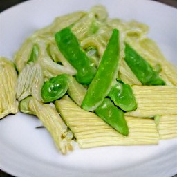 the pasta and veggies are transferred to a large pot. the grated parmesan cheese, soft cheese, lemon zest, lemon juice, basil, a quarter tsp of salt and 2 tbsp of the cooking water are added. the contents of