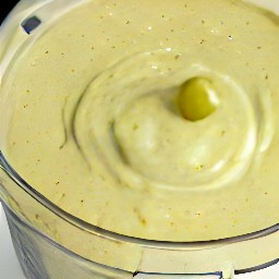 a dip made from artichokes, green olives, pine nuts, parmesan cheese, lemon juice and vegetable oil.