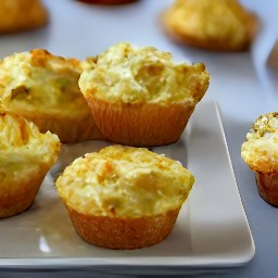 the muffin tin contains triple cheese and onion muffins.