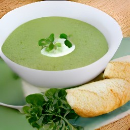 a bowl of watercress and celeriac soup with goat cheese and watercress sprigs, served with a side of toasted french baguette.