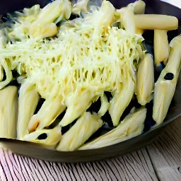a dish of pasta with zucchini, garlic, onions, salt, black pepper, sour cream and grated parmesan cheese.