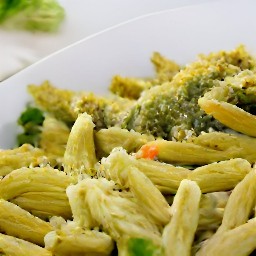 a dish with pesto crumbs and toasted pine nuts.