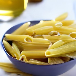 the pasta is transferred to a bowl and drizzled with olive oil.