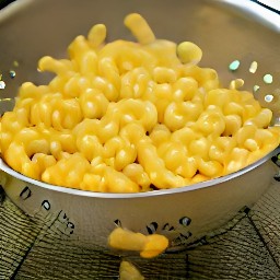 the cooked macaroni pasta is drained in a colander.