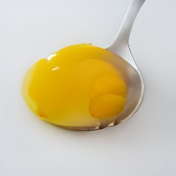 the egg yolks are in the slotted spoon.