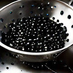 a colander full of rinsed and drained black beans.
