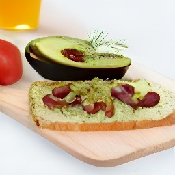 the avocado mixture is divided onto the bread thins with red kidney beans.