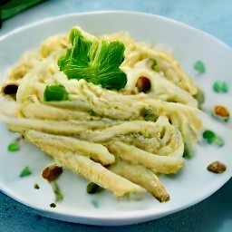 a plate of spaghetti with hazelnuts, olive oil, garlic, oregano, lemon zest, whipping cream, and parmesan cheese.