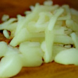peeled onions and garlic that are chopped.
