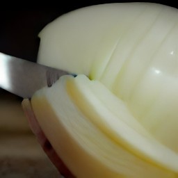 a peeled and sliced onion, and a peeled garlic clove.