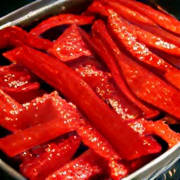 the red bell pepper strips are in a roasting tin.