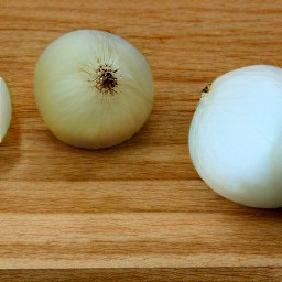 the output is a peeled and sliced onion, carrot strips, tomato wedges, and cucumber sticks.