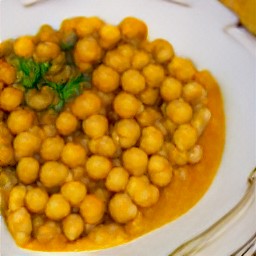 a plate of chickpea curry topped with coriander.