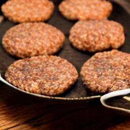 the burgers are flipped over with a spatula.