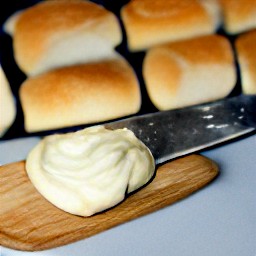 two halves of a floury roll, each spread with mayonnaise.